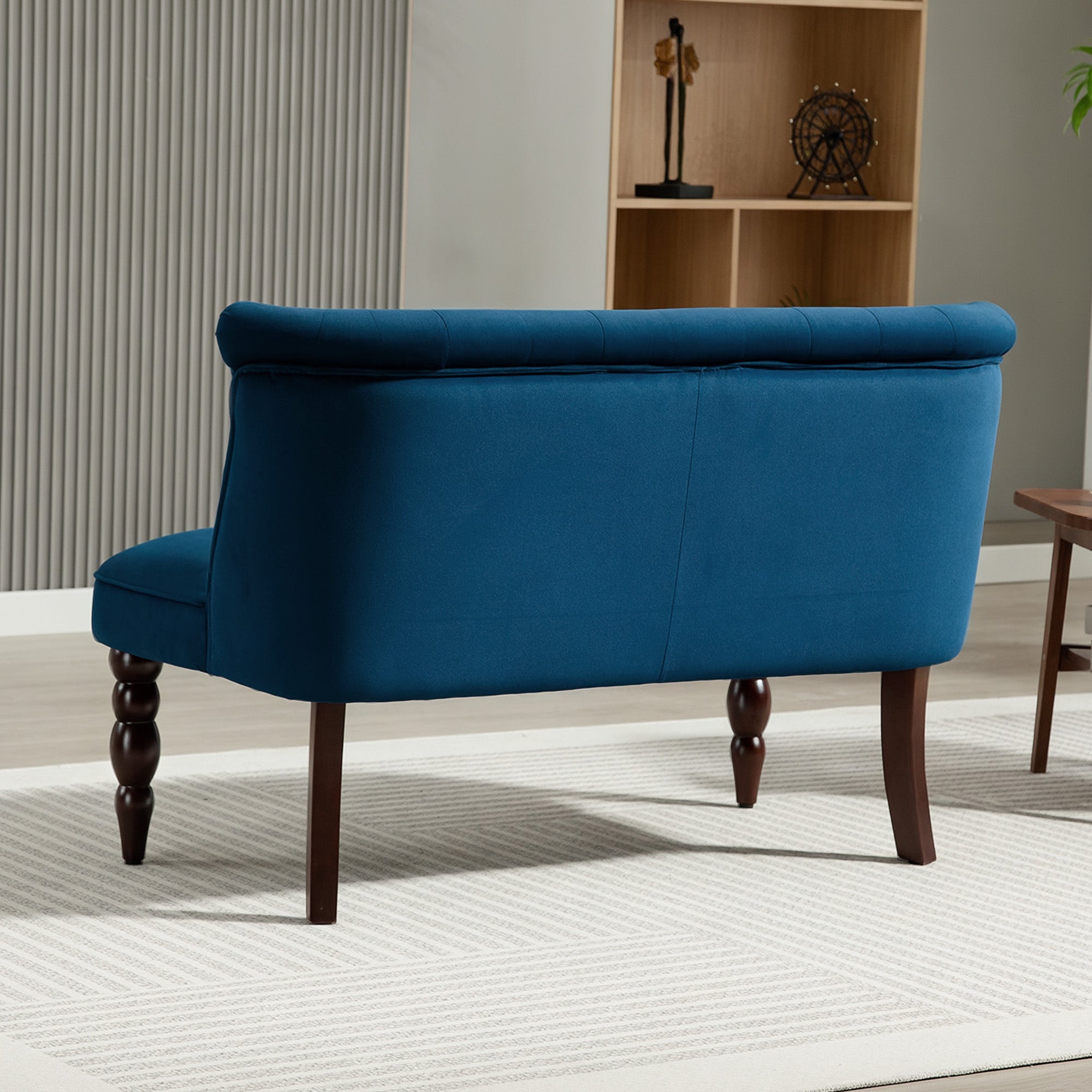 A plush navy blue velvet button tufted wingback bench with rubber wood legs perfect for living room seating