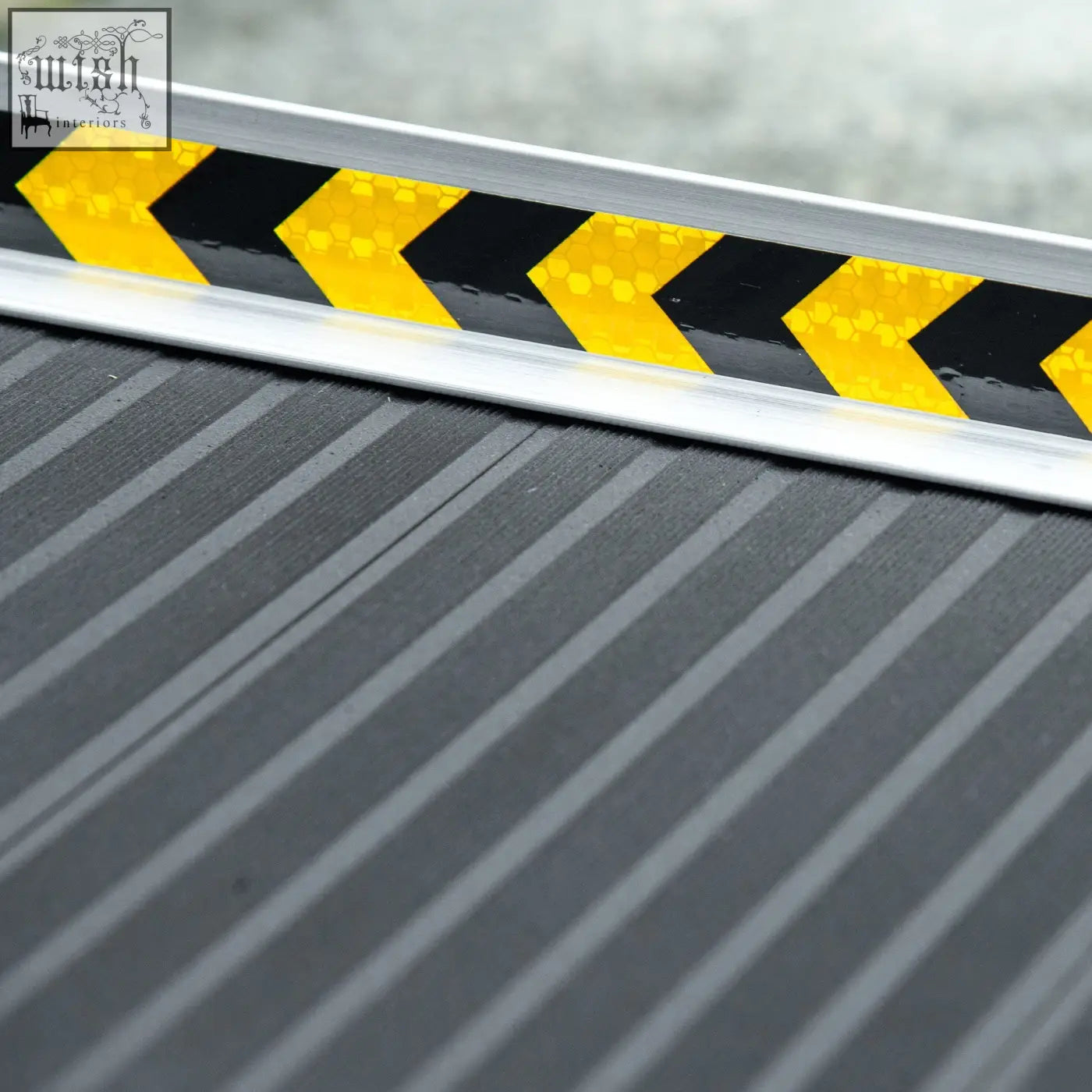 Silver aluminium alloy bumper guard with black and yellow reflective chevron stripes on homcom wheelchair ramp threshold ramp