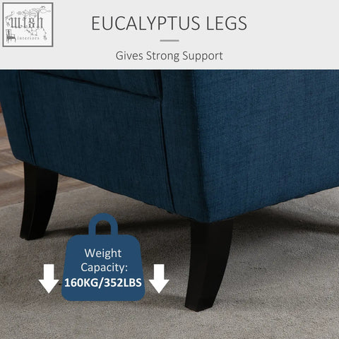 Deep blue upholstered wingback accent chair with button tufted back and dark eucalyptus floor height legs