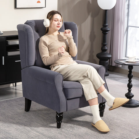 Charcoal grey velvet wingback accent chair with tufted backrest and black wooden legs at floor height for living room