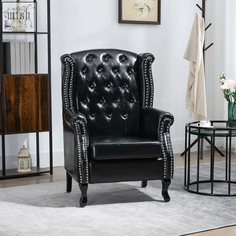 Black leather wingback armchair with tufted seat cushion and silver nailhead trim on eucalyptus wood frame for living room