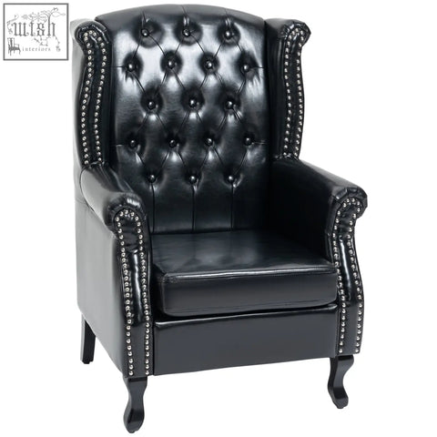 Black leather wingback armchair with tufted seat cushion and silver nailhead trim on eucalyptus wood frame for living room