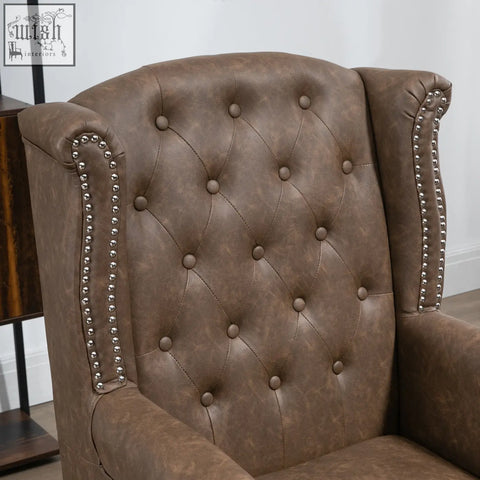 Brown tufted leather wingback chair with nail head trim and soft seat cushion for living room or bedroom use