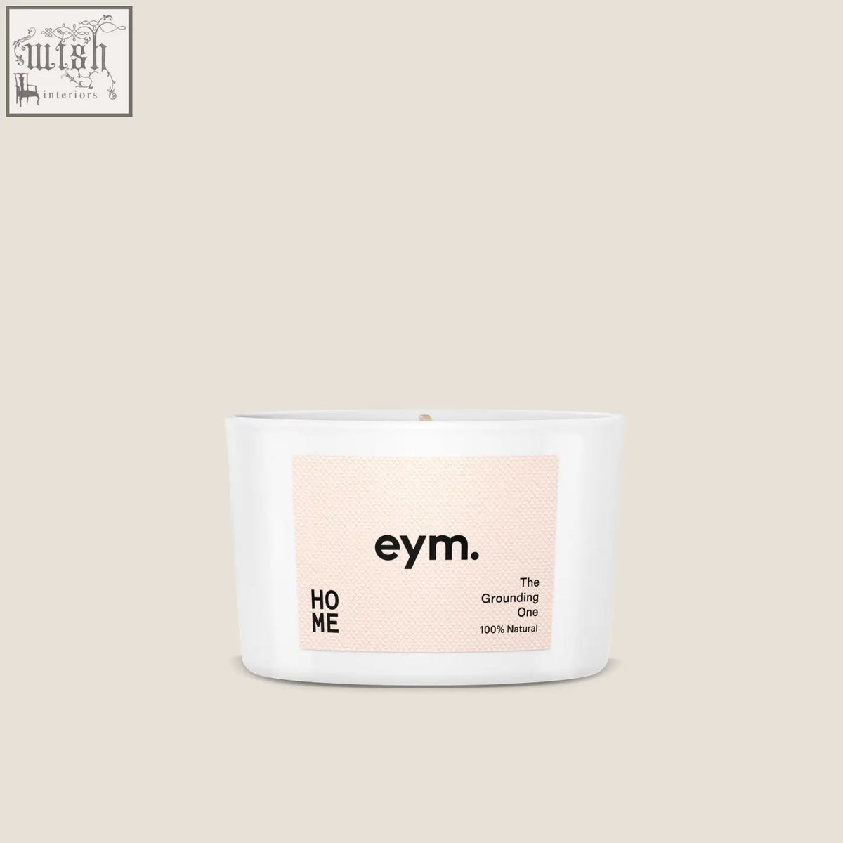 White ceramic mini candle with minimalist eym label the grounding one on soft peach background for home use