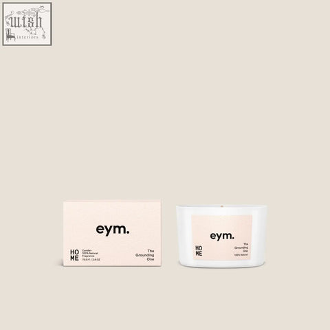 White ceramic mini candle with pale pink label and black text next to its minimalist matching box for home decor