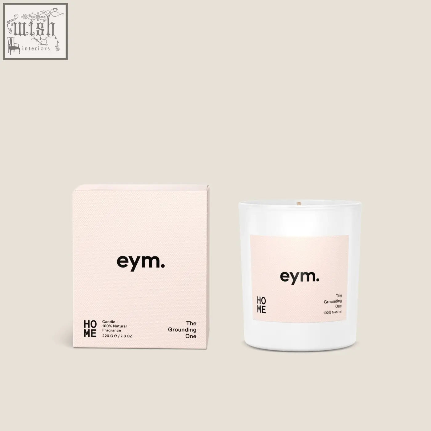 A minimalist white glass standard candle with a soft pink eym label and matching blush box called the grounding one