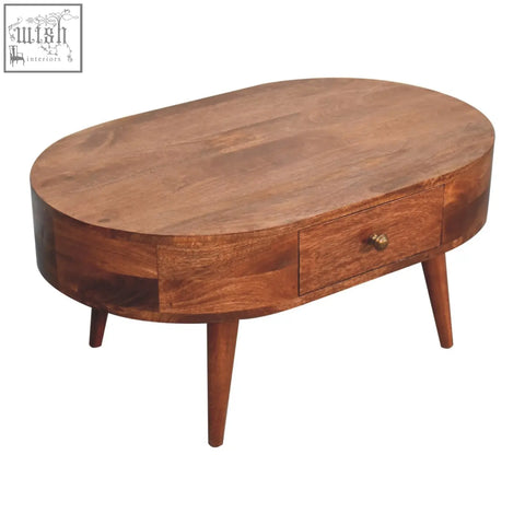Warm brown honey caramel coffee table with oval shape, single drawer, tapered legs, and honey caramel finish