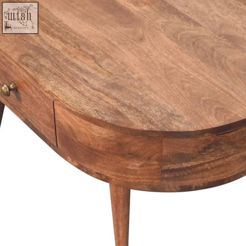 Warm-toned honey caramel coffee table with curved edge and brass-finished drawer pull in honey caramel finish