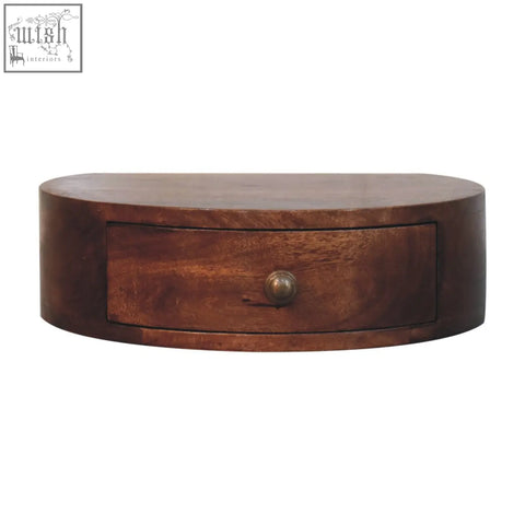 Dark brown oval wooden wall-mounted drawer with brass knob in honey caramel finish rounded bedside table