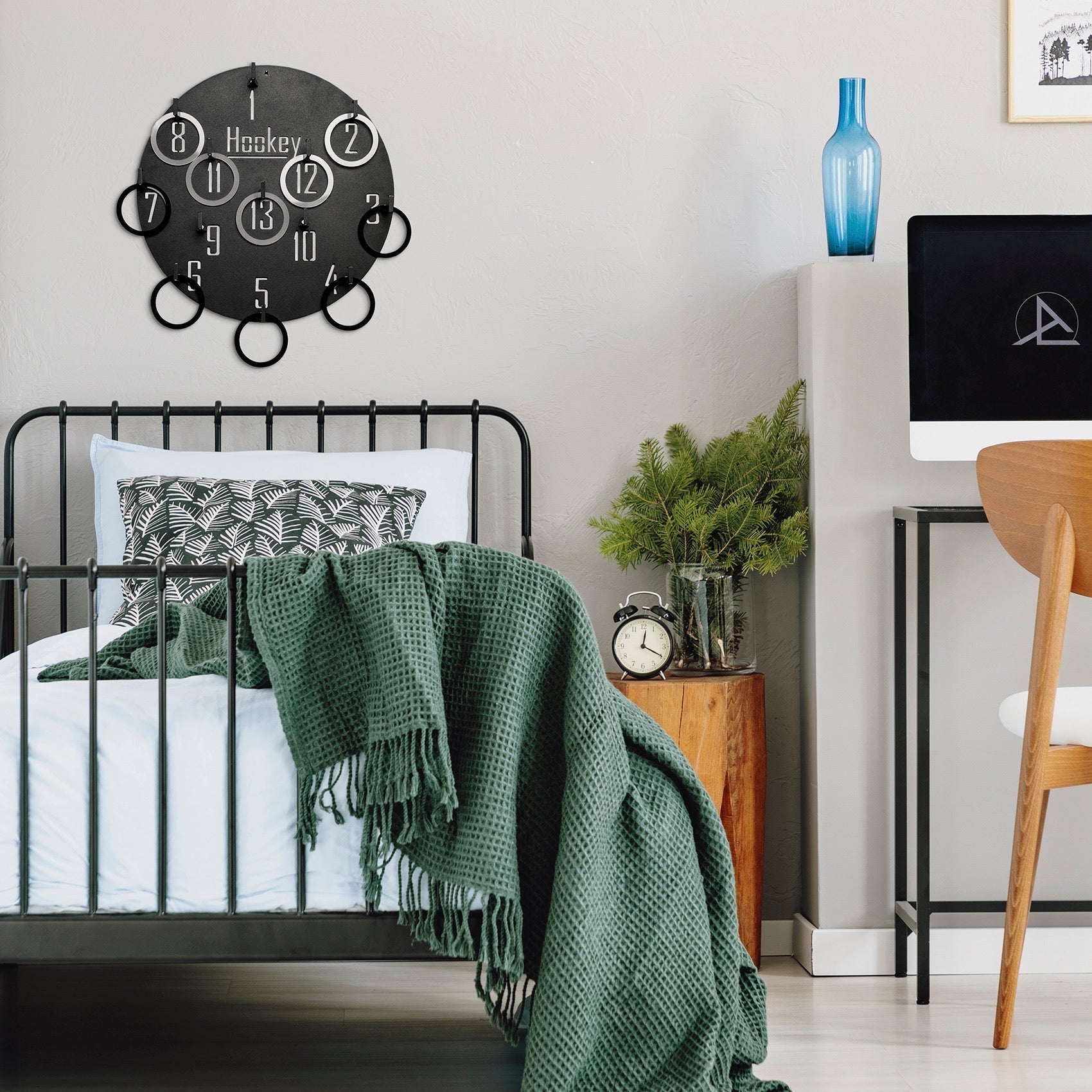 Black circular wall clock with white numerals and hanging ring accents from hockey hookey ring toss wall game for all ages