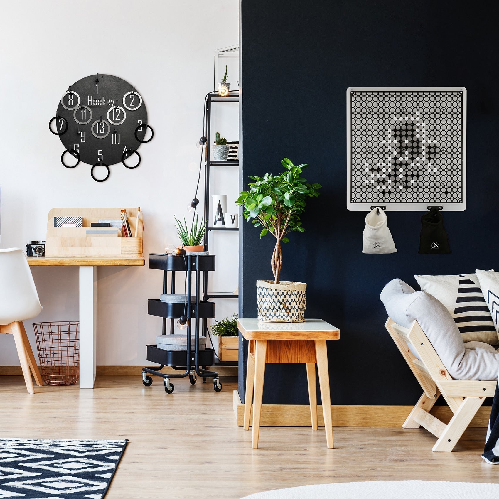 Black circular wall clock with white numerals and hanging ring accents for the hookey ring toss wall game age range 6+