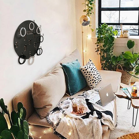 Black circular wall game organizer with hooks and rings for hanging items suitable for all age ranges