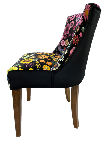 Black upholstered horton chair with vibrant pink yellow and orange floral patterns on backrest and seat