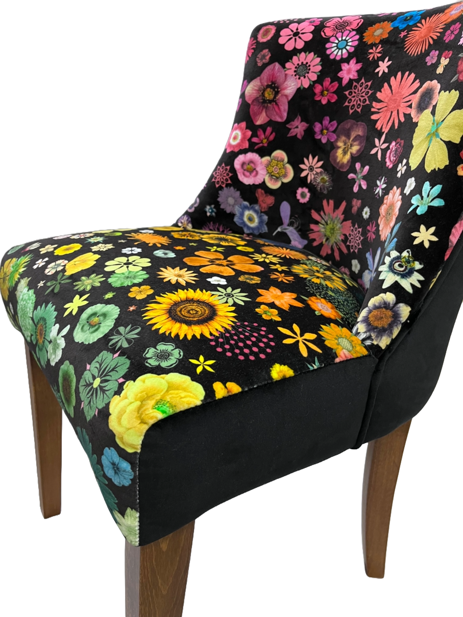 A vibrant floral-patterned horton chair upholstered in plush black velvet with pink yellow green and blue flowers