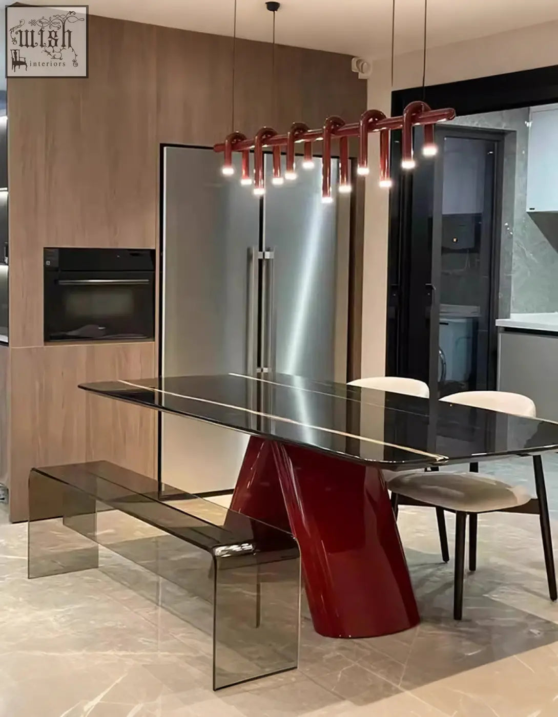 Red glossy pedestal dining table with sleek black marble top and transparent acrylic bench for stylish marble dining