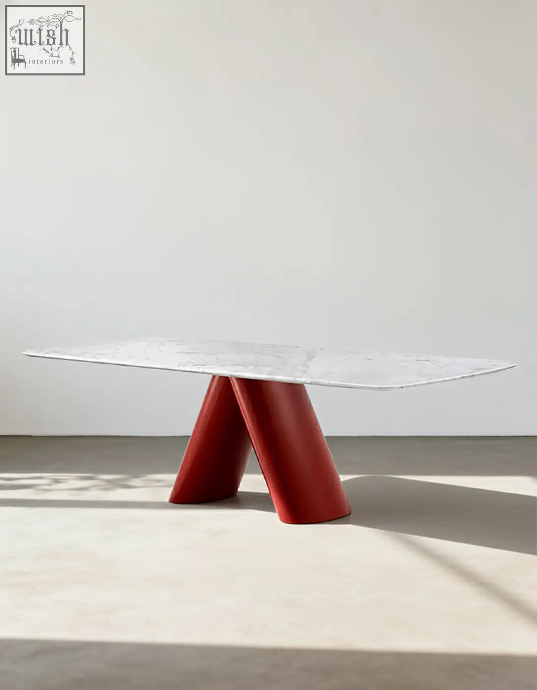 A sleek hossain dining table with a marble top and bold glossy red v-shaped legs perfect for marble dining rooms