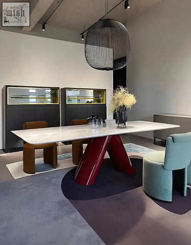 A sleek hossain dining table with a white marble top and bold glossy red v-shaped legs perfect for marble dining