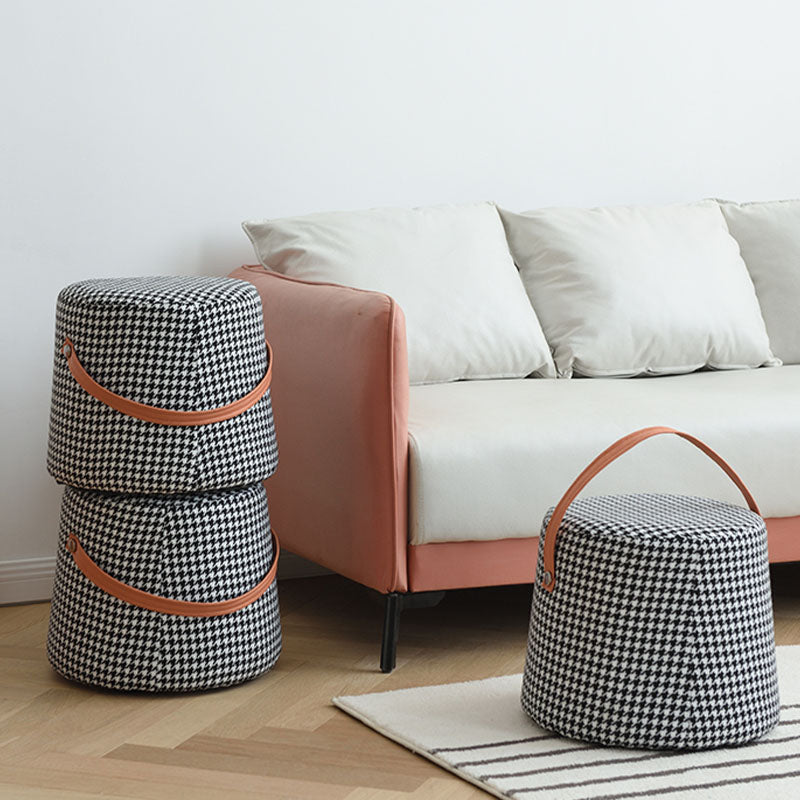 Houndstooth round footstool with black and white houndstooth fabric and tan leather handles storage baskets