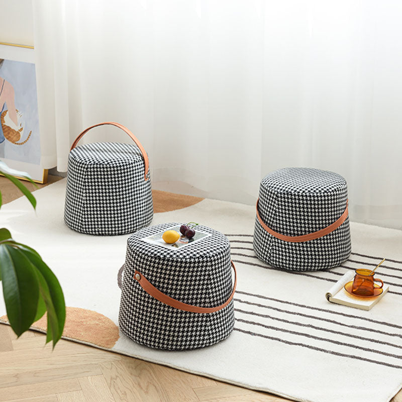Black and white houndstooth round footstool with tan leather handles perfect as a stylish round footstool