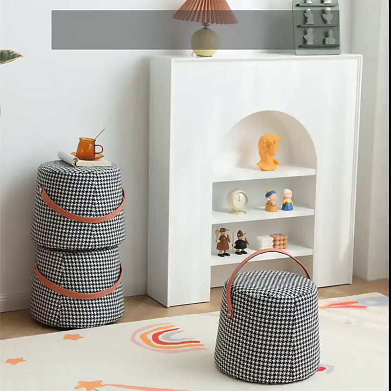 Stacked black-and-white houndstooth round footstool fabric storage bins with pink leather handles for stylish organization