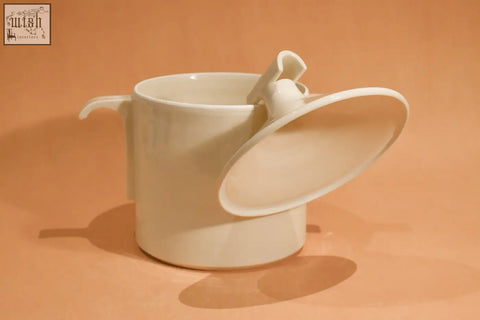 Cream-colored ceramic house jar mug with sleek minimalist design and integrated lid with small handle, no borosilicate glass