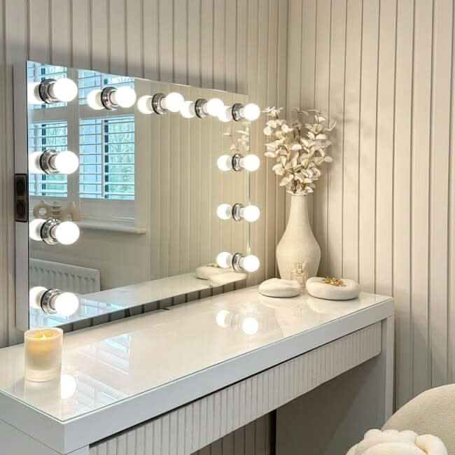 A sleek white houston bluetooth hollywood mirror 80x60cm with bright light bulbs and built-in audio bluetooth speakers