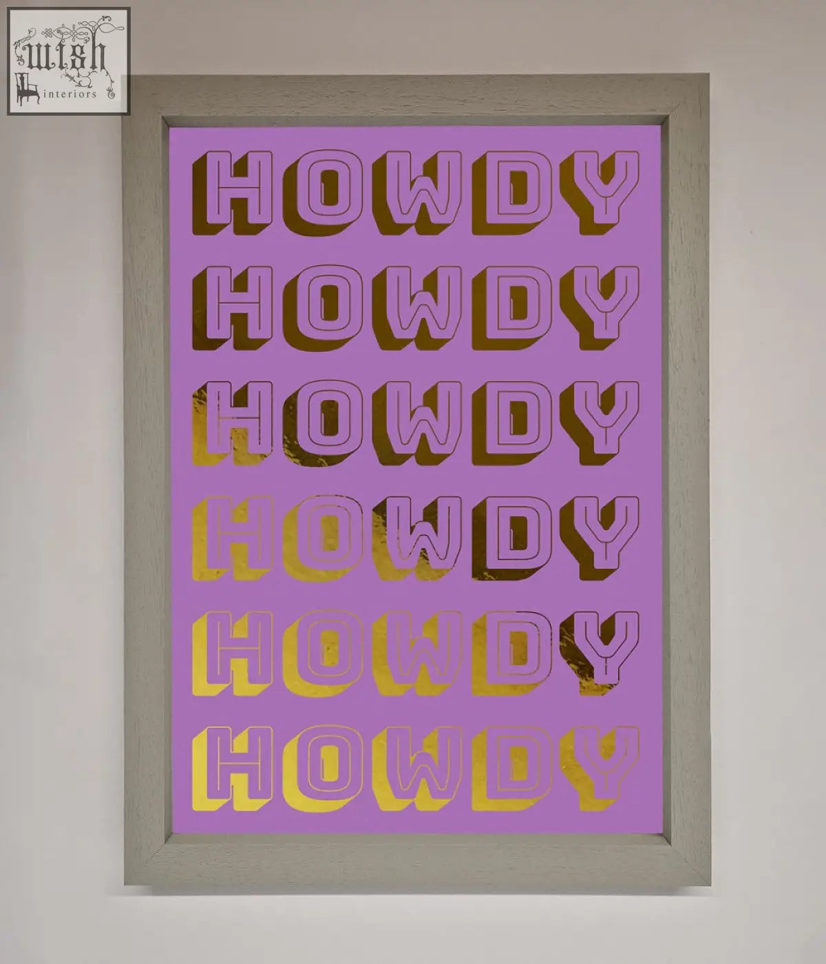 A framed howdy foil print with bold pink to gold foil lettering on a solid lavender background