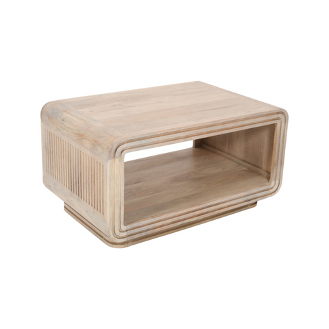 Light-colored hudson carved mango wood coffee table with recessed sides and vertical slats on one side