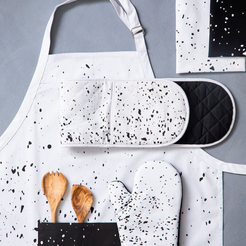 White hygge apron with black speckle pattern and adjustable fit strap for comfy cooking and crafting sessions