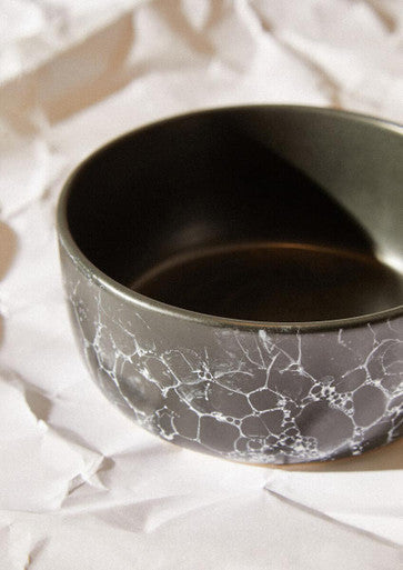 A sleek black faux marble bowl with a white crackle glaze pattern perfect for stylish serving or decor