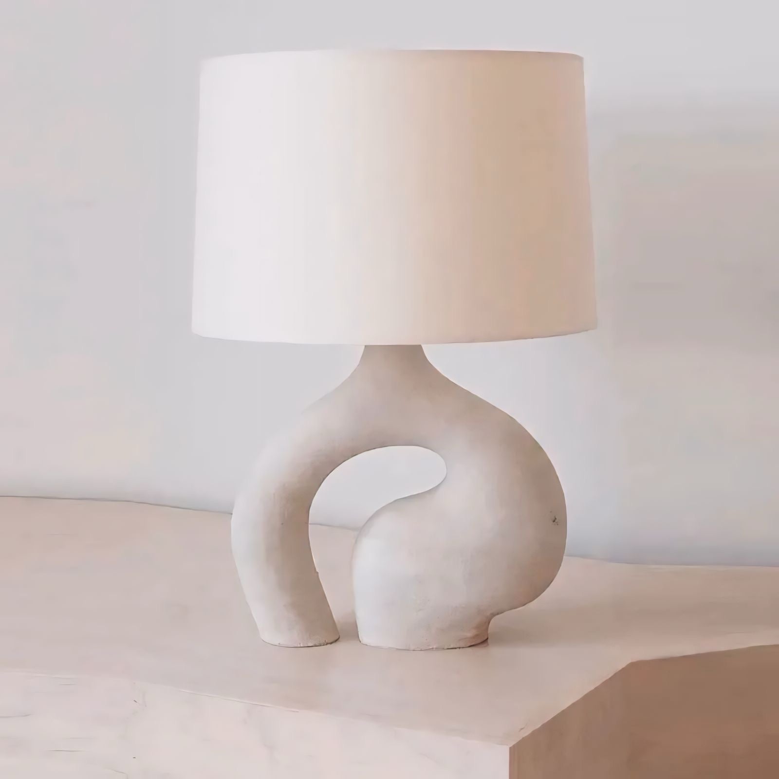 Hyung light cream-colored ceramic table lamp with sculpted organic base and soft white cylindrical shade
