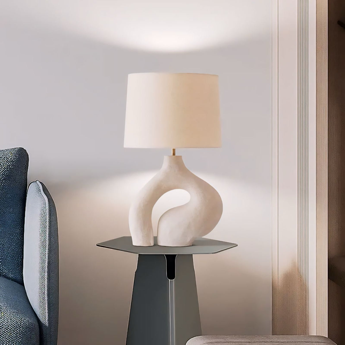 Cream-colored ceramic hyung light table lamp with sleek abstract sculptural base and soft beige fabric shade