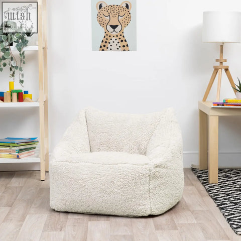 Cream kids bean bag chair made of plush teddy fleece with cozy rounded design perfect for nursery decor