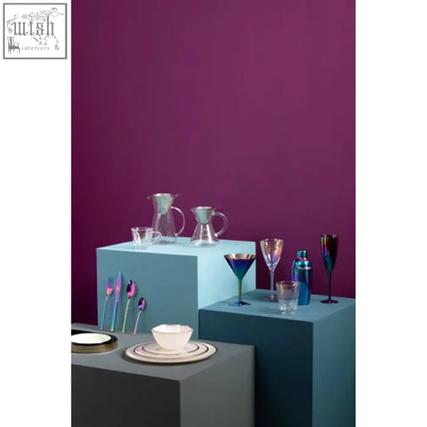 Set of modern glassware with metallic accents paired with clear ida embossed glass coupe charger plate with silver rim