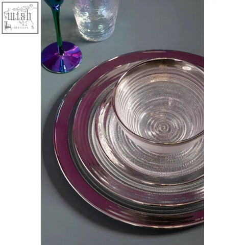Set of clear glass coupe charger plates with shimmering purple rim and concentric circular patterns
