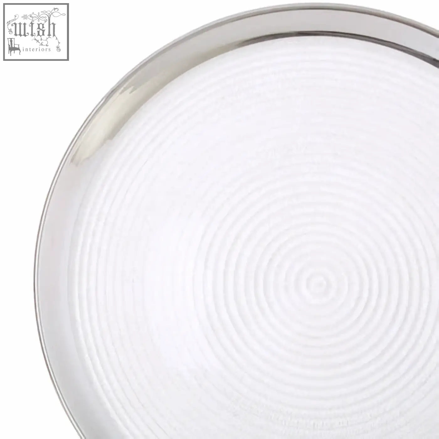 Silver-rimmed glass coupe charger plate with white embossed concentric circles textured surface