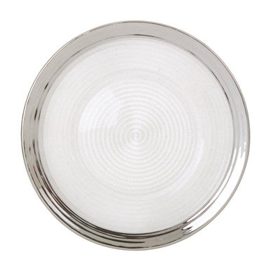 Circular ceiling light with polished chrome frame and frosted glass diffuser next to an embossed glass dinner plate with silver rim