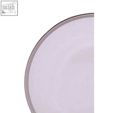A sleek white glass charger plate with a silver rim and minimalist ceramic design perfect for elegant dining