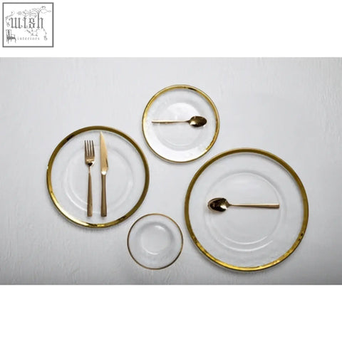 Set of ida textured glass side plates with gold rim and matching gold utensils for elegant table settings