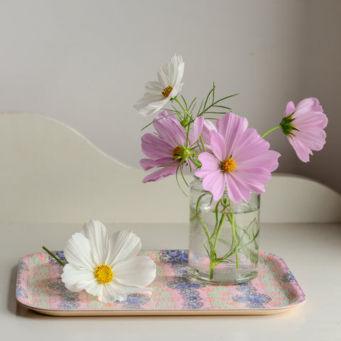 A clear glass jar with pink and white cosmos flowers on an ida wooden tray perfect for decor or gifts