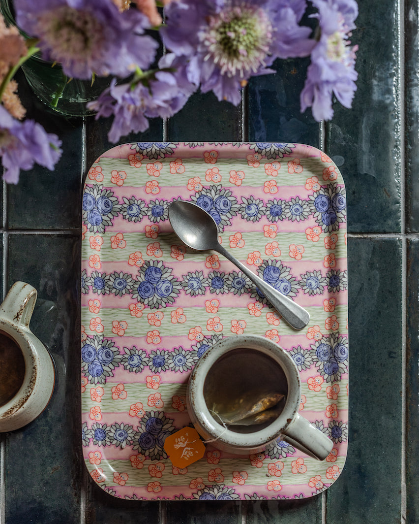 Ida wooden tray featuring a pink floral pattern with pastel stripes and blue and orange flowers on wood