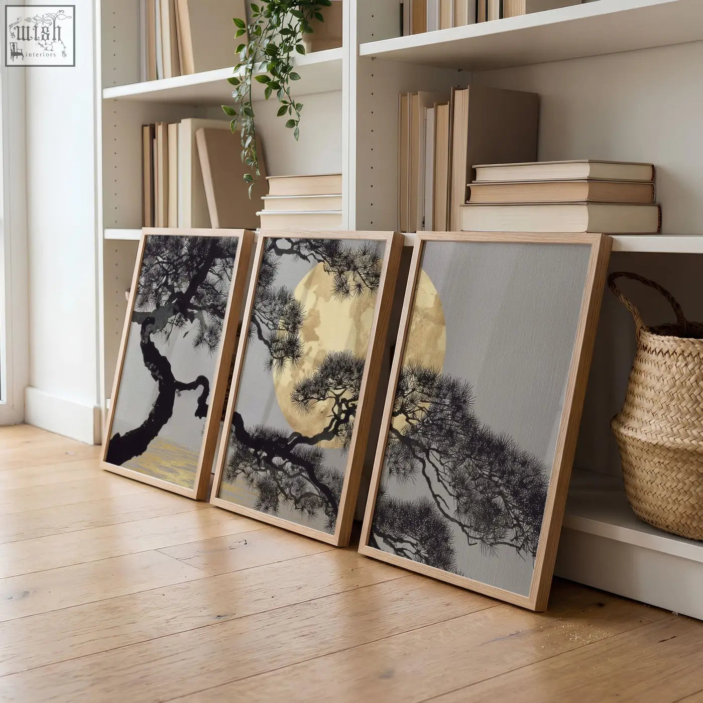 Three framed living room wall art pieces with black pine trees and gold circles on grey in light wood frames