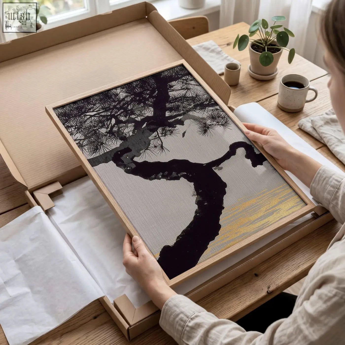 Minimalist living room wall art featuring black pine tree on textured gray and gold background in light wood frame