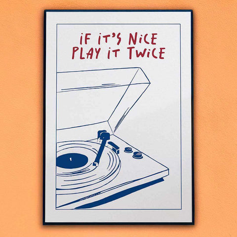A framed print featuring a minimalist blue line drawing of a record player with nice play text in red above it