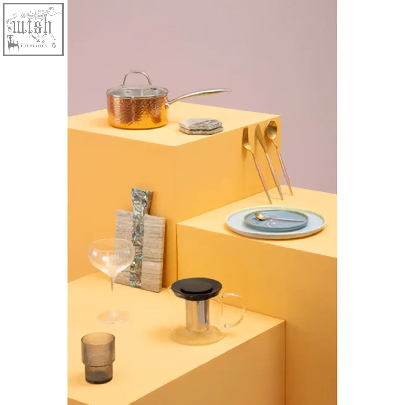 Gold-colored copper pot with glass lid shown on four beige marble and paua shell coasters from imogen set of 4