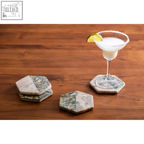 Hexagonal four beige marble coasters with paua shell inlays and natural gray green veined pattern from imogen set