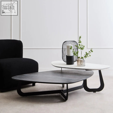 Modern black and white large asymmetrical ceramic coffee table with sleek curved metal legs and nesting design