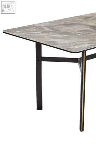 Modern rectangular dining table with ceramic marble effect gray top and black metal legs with gold accents