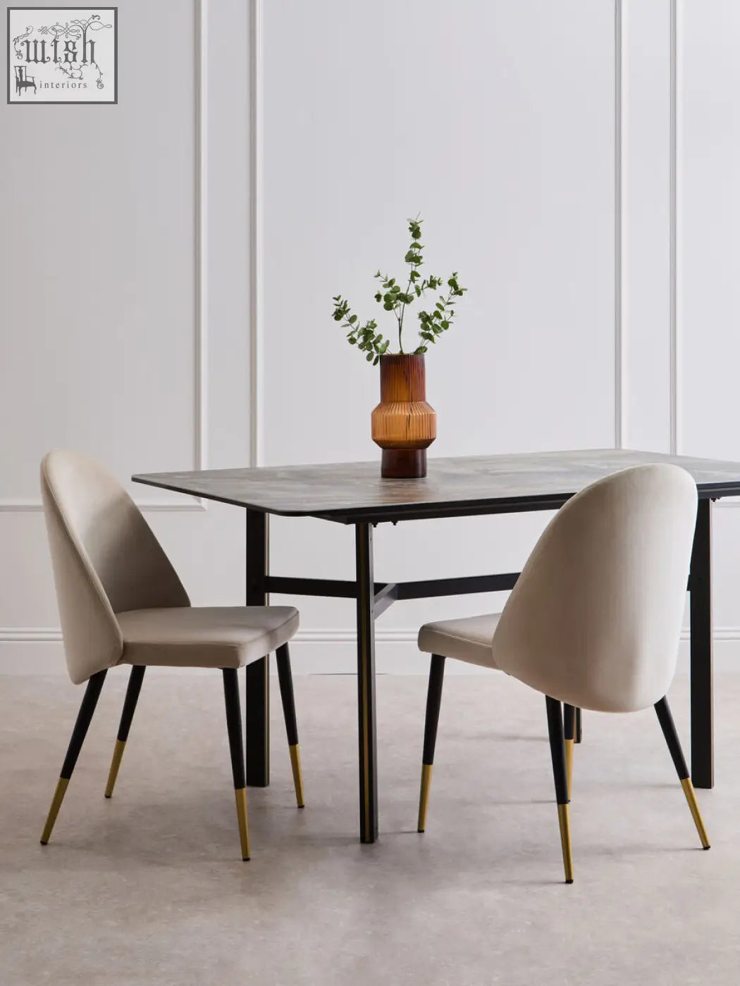 Imperia rectangular dining table with sleek black ceramic marble effect top and slender metal legs with gold tips