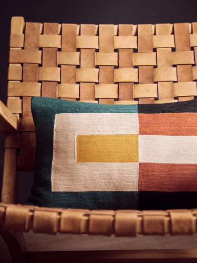 Teal mustard geometric cushion on inca armchair with brown leather straps and american oak teak wood frame